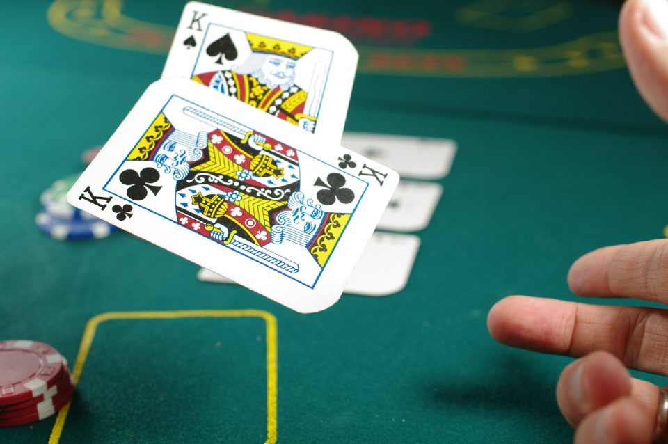 Playing cards and casino chips on green felt
